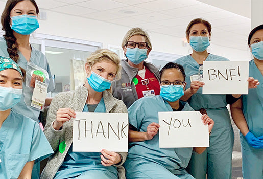 Team holding up thank you message